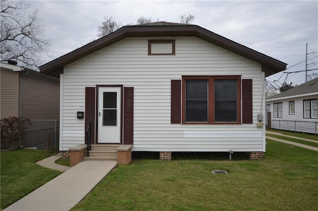 bungalow-style home featuring a front yard