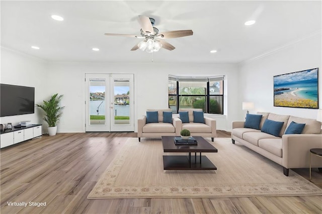 living area featuring wood finished floors, baseboards, recessed lighting, ceiling fan, and ornamental molding