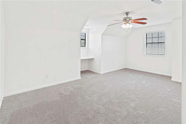 bonus room with visible vents, ceiling fan, baseboards, vaulted ceiling, and carpet floors