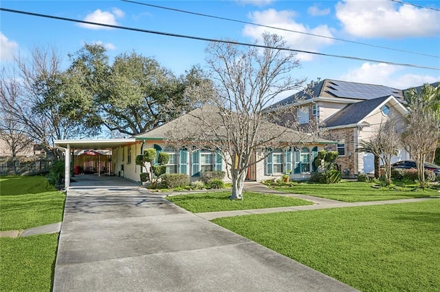 view of front of house with a front yard and a carport