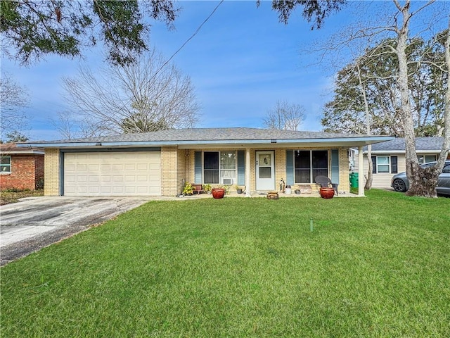 ranch-style house featuring a garage, covered porch, and a front lawn