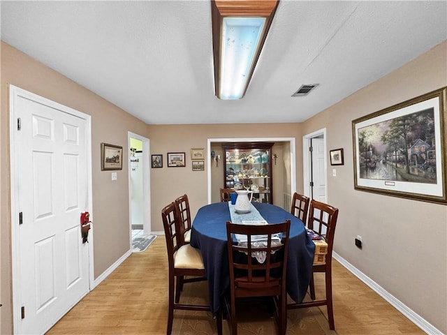 dining space with light hardwood / wood-style flooring