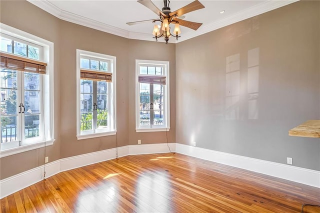 empty room featuring ornamental molding, hardwood / wood-style flooring, and ceiling fan