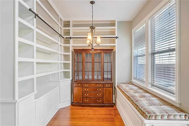 unfurnished dining area featuring hardwood / wood-style flooring and a chandelier