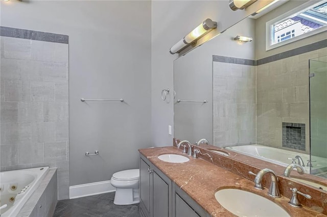 bathroom featuring vanity, toilet, and tiled tub