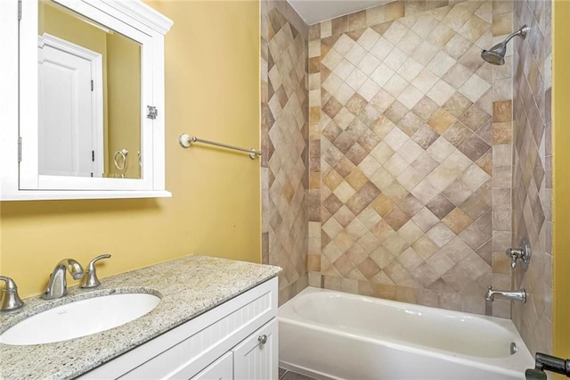 bathroom with vanity and tiled shower / bath