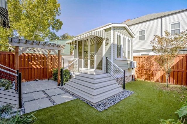 rear view of house with a patio and a lawn