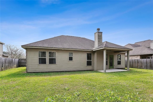 rear view of property featuring a yard and a patio