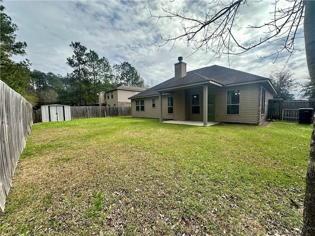 back of property featuring a shed, a patio, and a yard