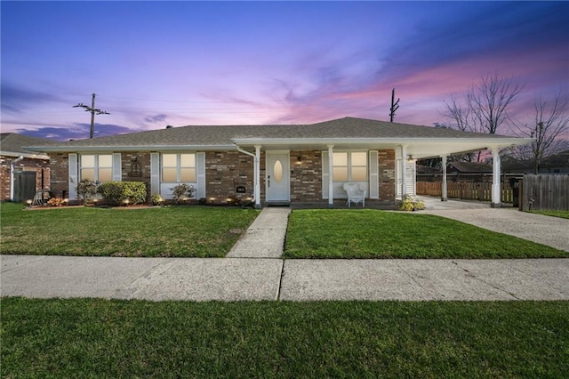 single story home with a carport and a lawn