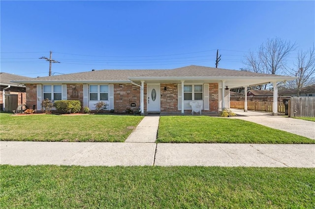 ranch-style house with a front yard and a carport