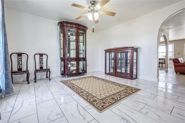 interior space with ceiling fan