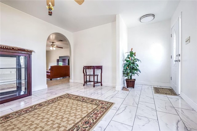 foyer entrance featuring ceiling fan