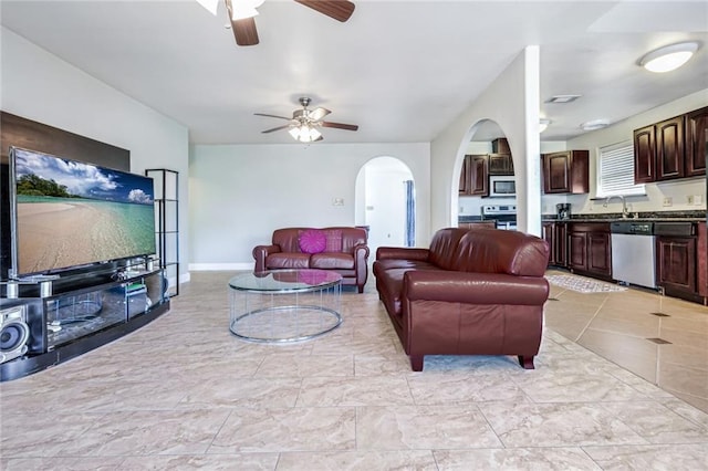 living room featuring sink and ceiling fan