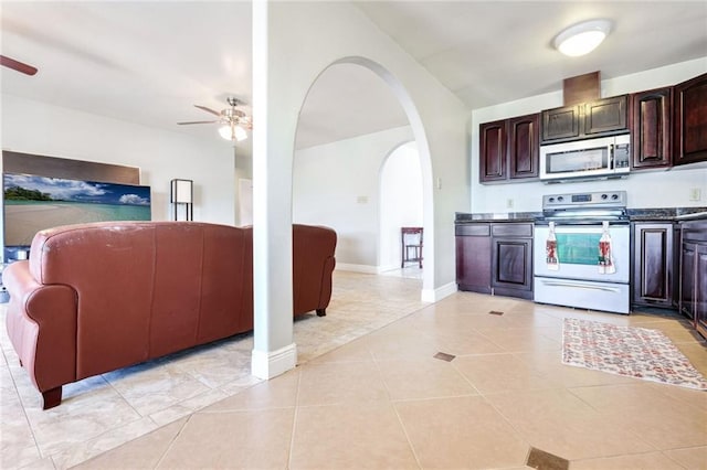 kitchen with dark brown cabinetry, ceiling fan, light tile patterned floors, and stainless steel appliances