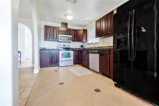 kitchen featuring sink, appliances with stainless steel finishes, and light tile patterned floors