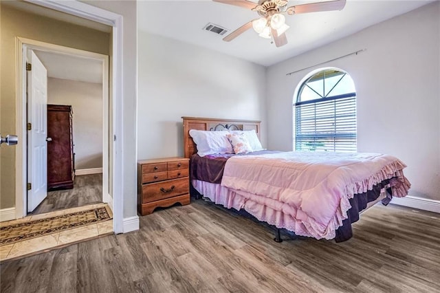 bedroom featuring hardwood / wood-style floors and ceiling fan