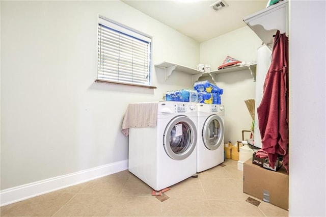 laundry room featuring light tile patterned floors and washer and clothes dryer