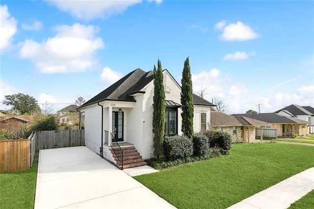 view of front of property with a front yard and fence