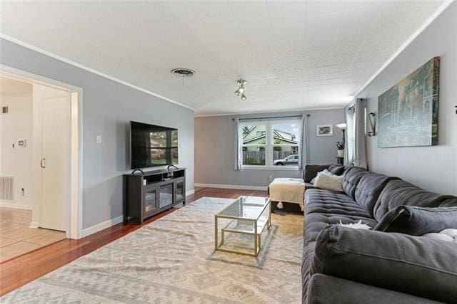 living room featuring crown molding and wood-type flooring