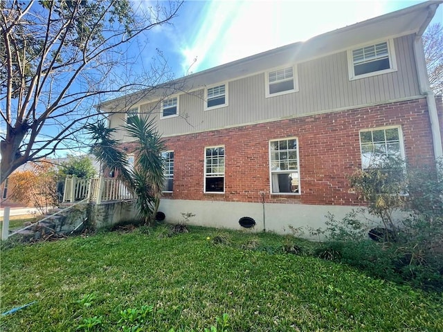 view of property exterior with a lawn