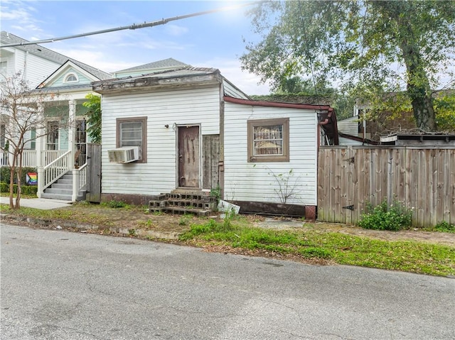 bungalow-style home with cooling unit