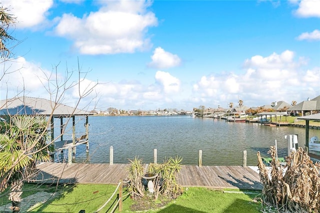 dock area featuring a yard and a water view