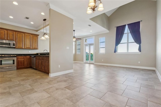 kitchen featuring hanging light fixtures, sink, ornamental molding, appliances with stainless steel finishes, and ceiling fan with notable chandelier