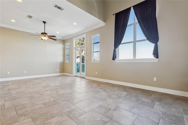 spare room featuring ornamental molding and ceiling fan