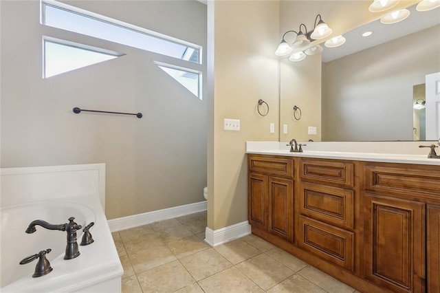 bathroom featuring a healthy amount of sunlight, tile patterned flooring, toilet, and vanity