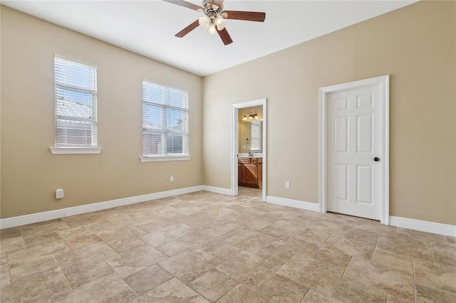 unfurnished bedroom featuring ensuite bathroom and ceiling fan