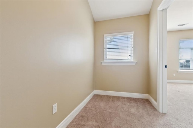 unfurnished room with light colored carpet