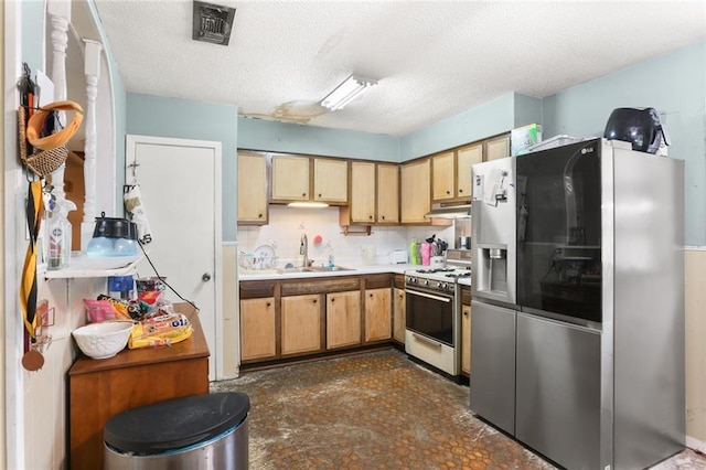 kitchen featuring sink, white range with gas cooktop, a textured ceiling, and stainless steel fridge