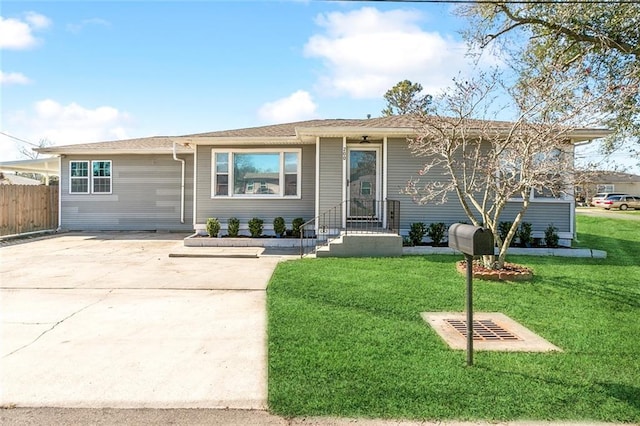 ranch-style house featuring a front lawn and a garage