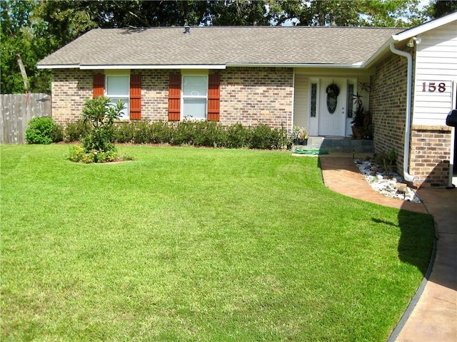 ranch-style house featuring a front yard