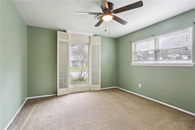 empty room with ceiling fan and light colored carpet