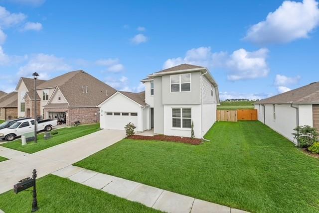 view of front property featuring a front yard and a garage