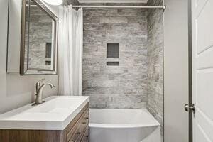 bathroom featuring shower / tub combo with curtain and vanity