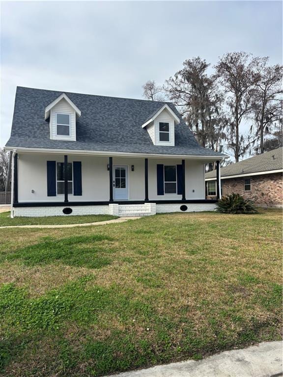 cape cod home featuring covered porch and a front lawn