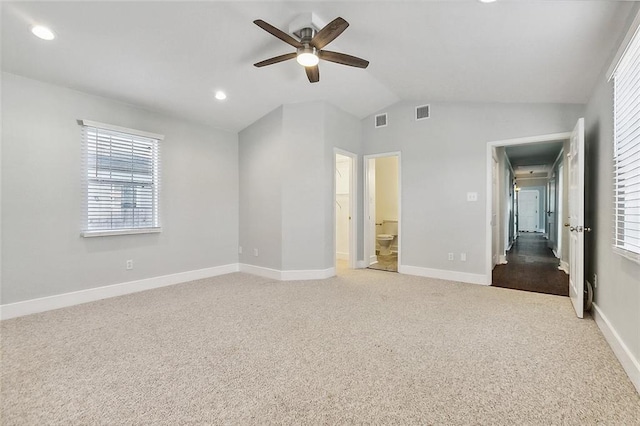 unfurnished bedroom with carpet floors, lofted ceiling, visible vents, and baseboards