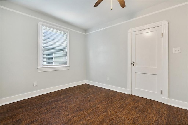 unfurnished room with a ceiling fan, dark wood finished floors, and baseboards