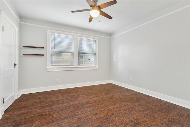 spare room featuring dark wood-style floors, baseboards, and a ceiling fan