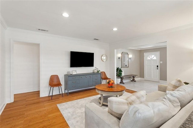 living room with ornamental molding and light wood-type flooring