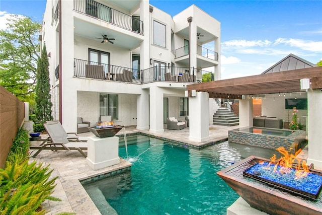 501 Emerald St, New Orleans, LA 70124 - rear view of property featuring an outdoor living space with a fire pit, stairs, stucco siding, and a balcony