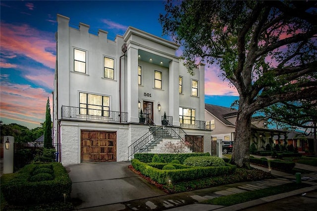 501 Emerald St, New Orleans, LA 70124 - view of front of house with stairway, a garage, driveway, and stucco siding