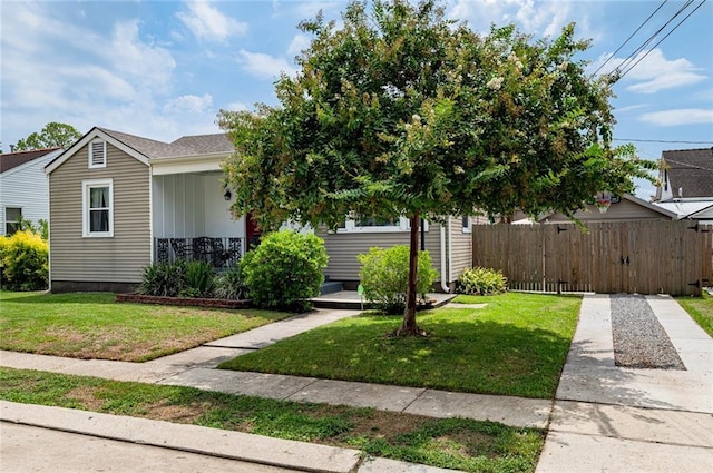 obstructed view of property with a front yard