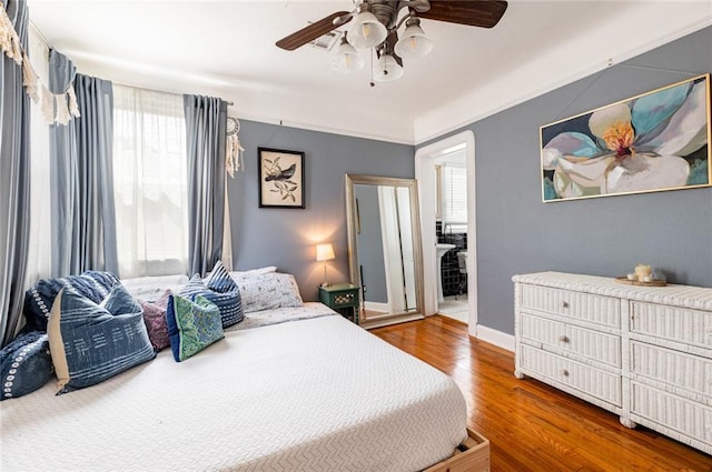 bedroom featuring hardwood / wood-style flooring and ceiling fan