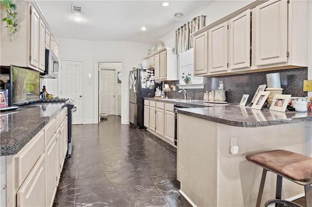 2021 W Ridge Dr, Mandeville, LA 70448 - kitchen featuring freestanding refrigerator, dark marble finish floors, a kitchen breakfast bar, backsplash, and recessed lighting