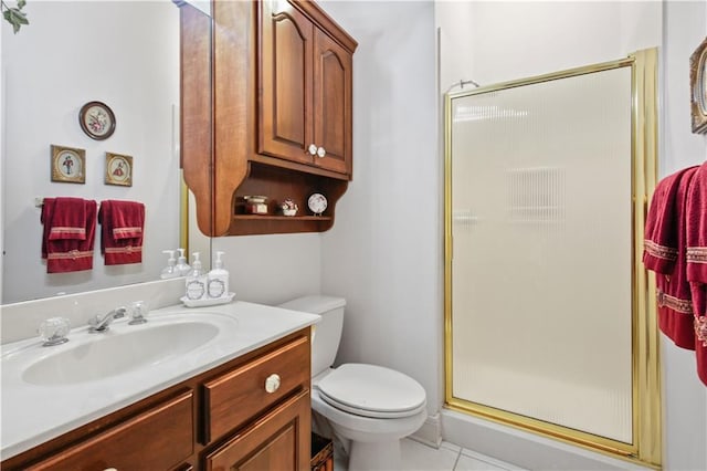 bathroom with vanity, toilet, tile patterned floors, and walk in shower