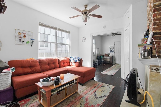 living room featuring ceiling fan and dark hardwood / wood-style flooring